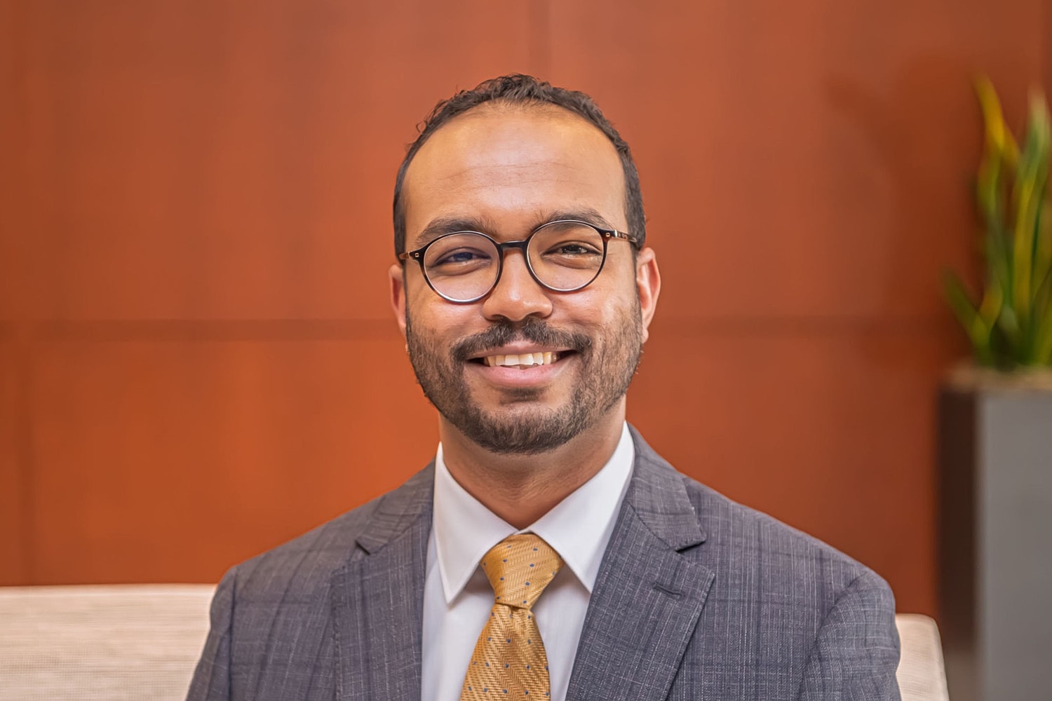 Smiling man in a suit and tie.