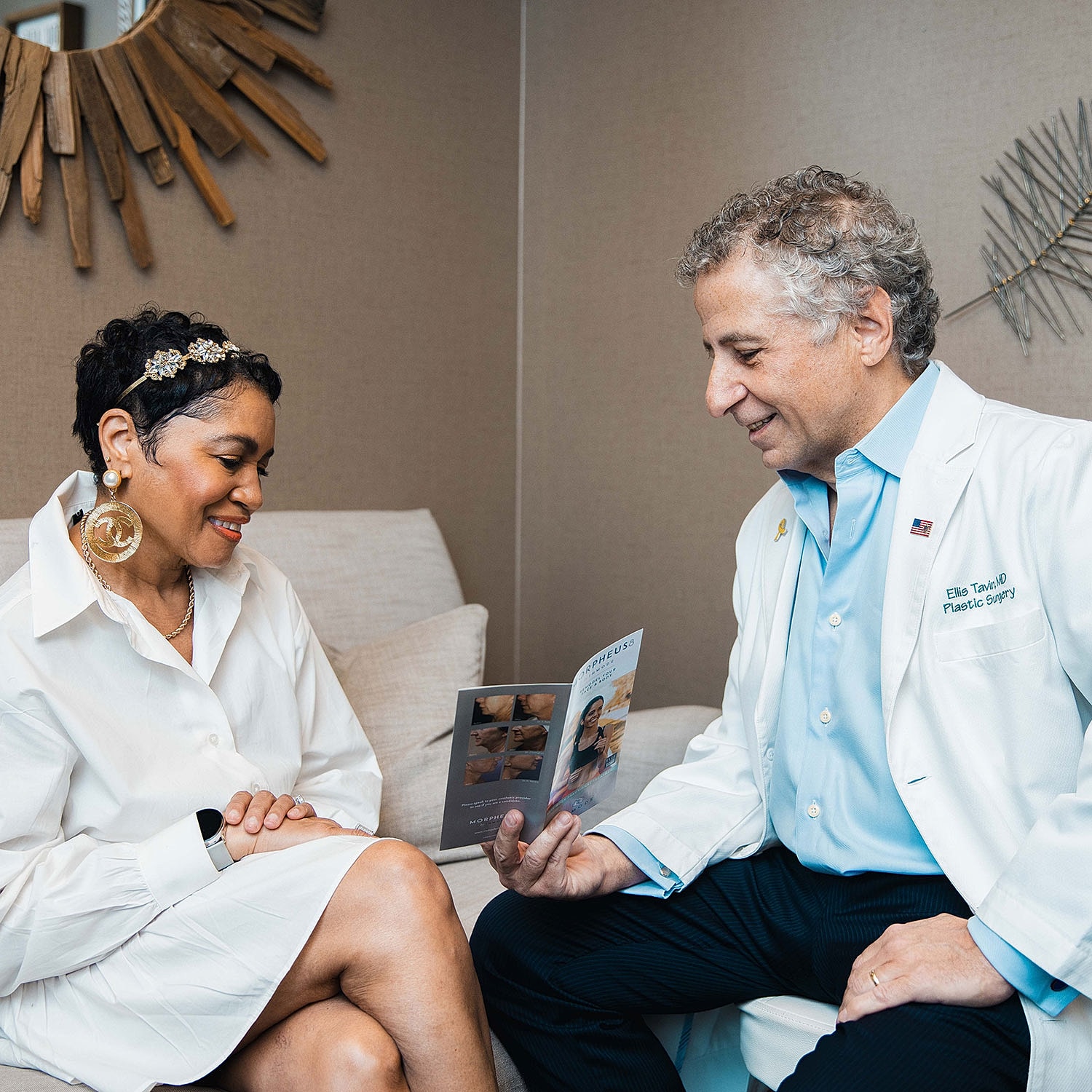 Patient consultation with plastic surgeon in office.