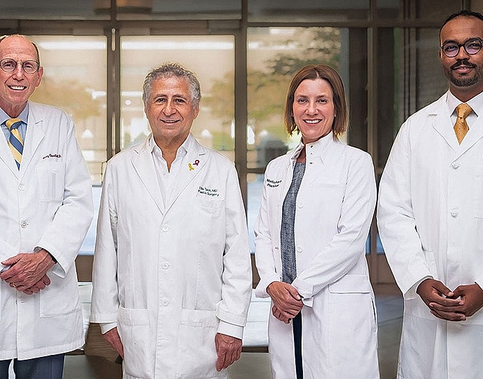 Four medical professionals in lab coats.