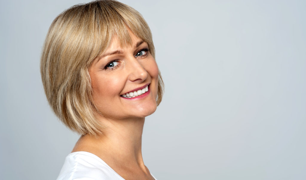 smiling middle aged lady with short blonde hair